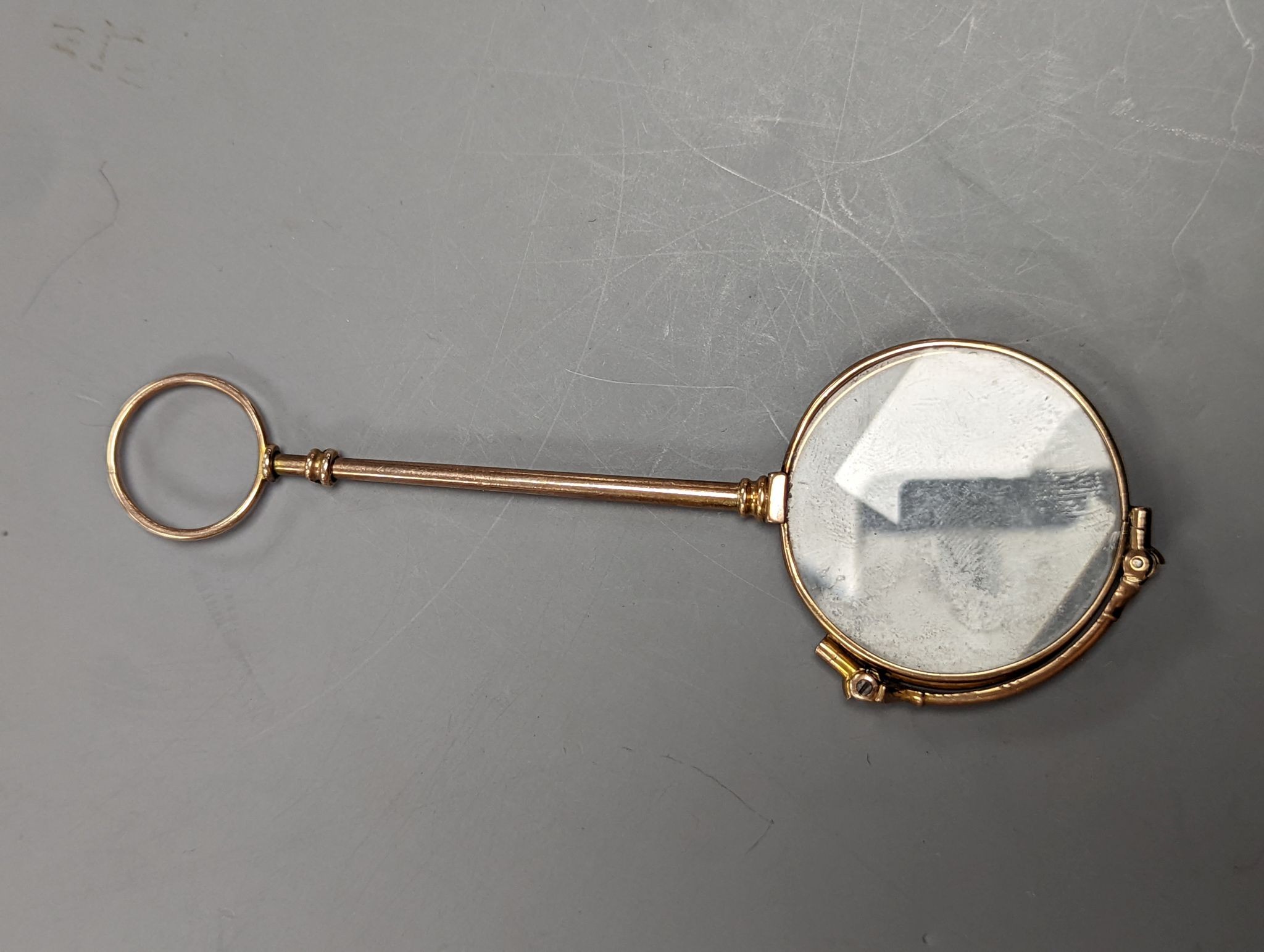 A George V engraved silver sovereign case, Birmingham, 1910, 29mm and a pair of gold plated lorgnettes.